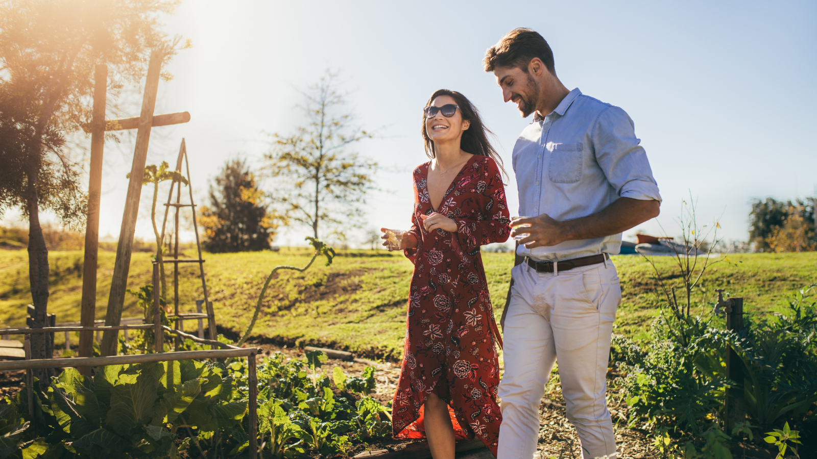 A young couple walking and talking about their future under the bright sun.