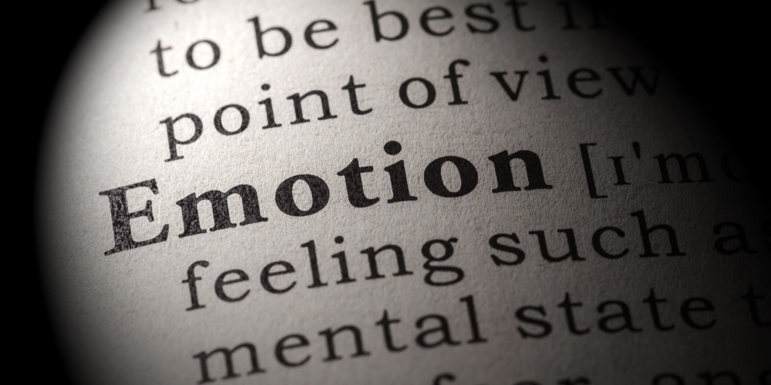 Close-up of the word 'Emotion' in a dictionary, highlighting the importance of emotions in relationships